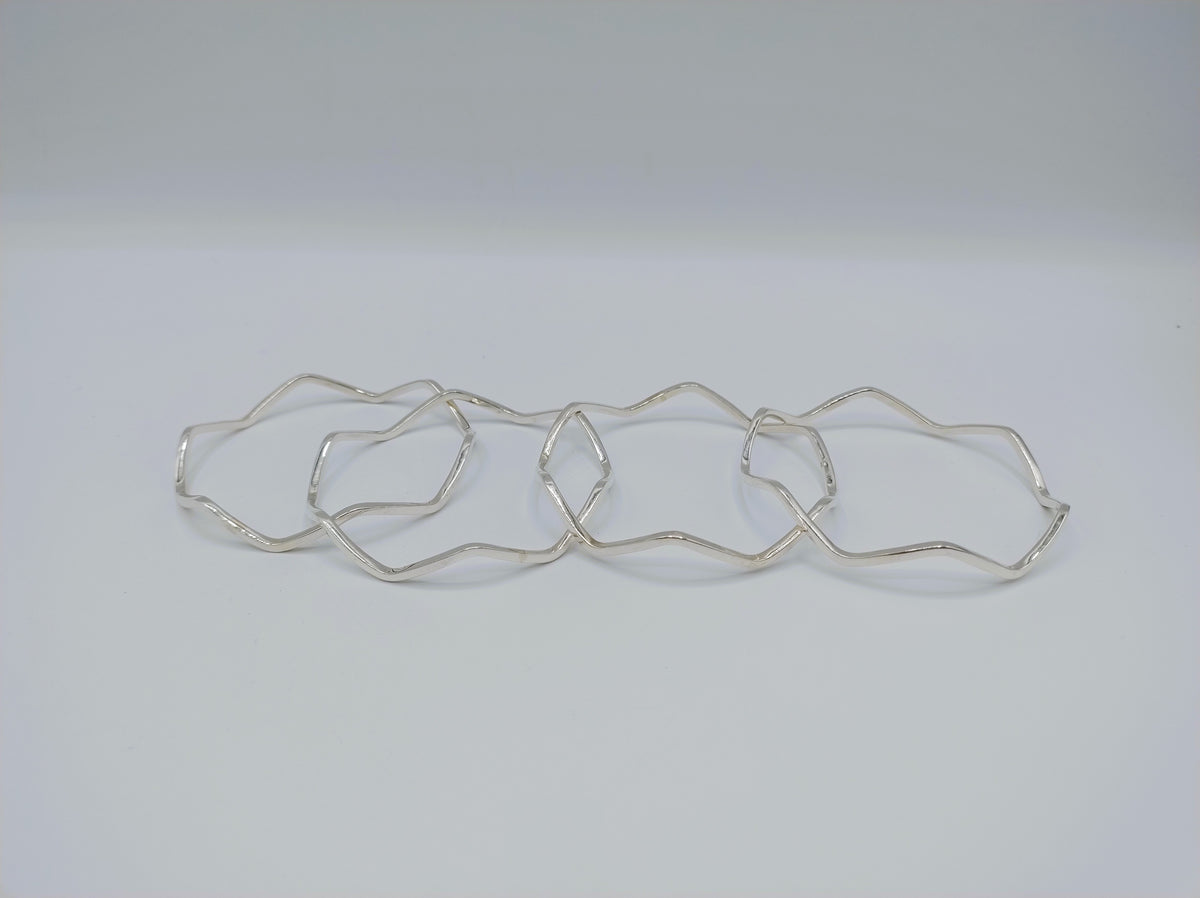 Set van 4 zilveren stervormige armbanden