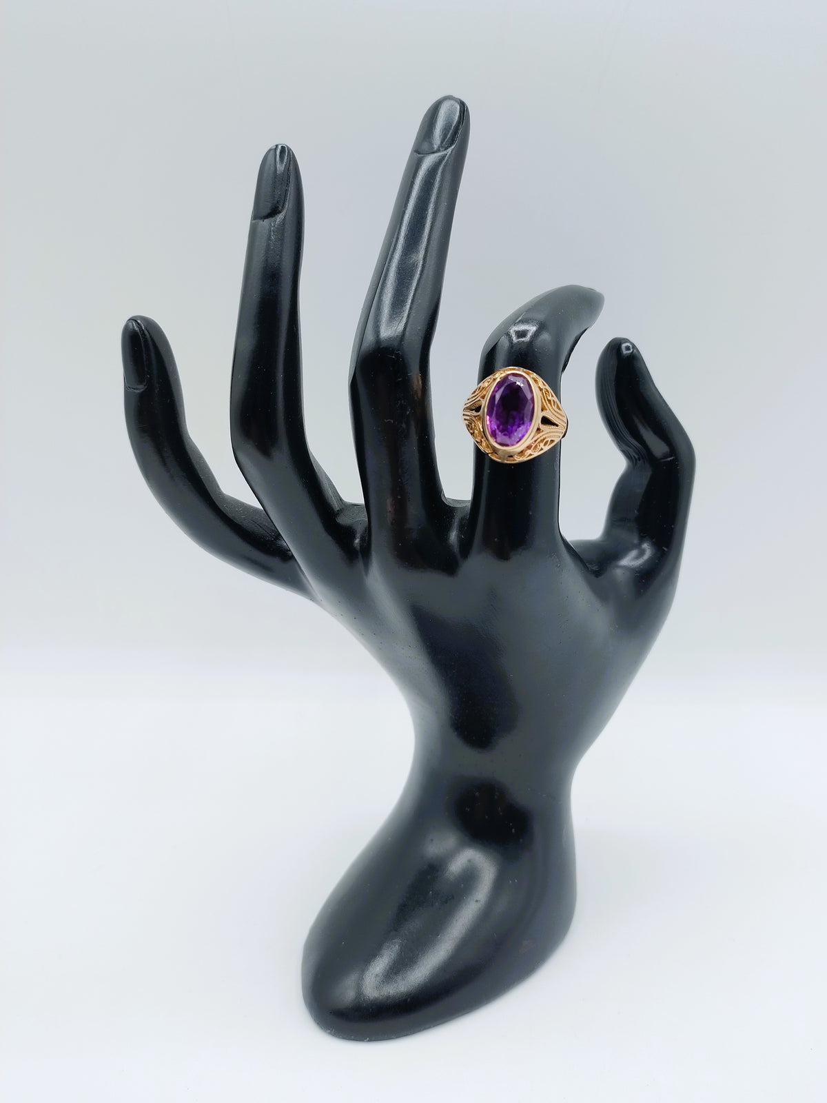 Gouden ring met ovale paarse amethist en gouden zetting, frontaanzicht