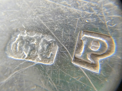Zilveren tasbeugel, close-up van stempel en randscript op het metaal